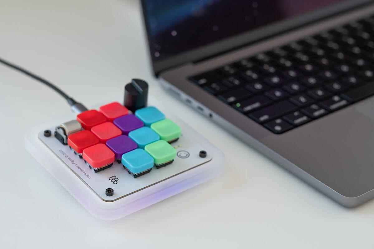 The Creator Micro macro pad next to a laptop